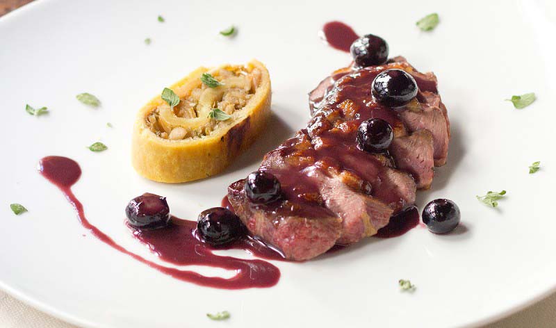 Duck breast and blueberrieswith cabbage hood and pine nuts rollè - Boccanegra Florence Restaurant